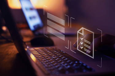 A close-up of a laptop keyboard with a person working in a dimly lit environment. Digital overlay icons appear above the keyboard, including a document with checkmarks and lines symbolizing data or text, suggesting digital compliance, regulations, or document management.